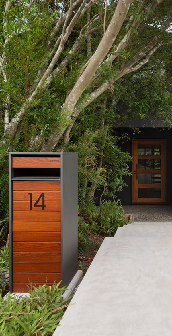 Modern mailbox with number 14 in front of a house