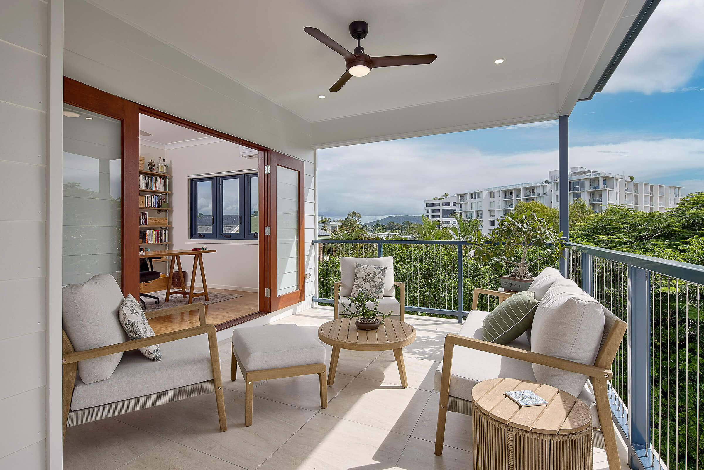 Outdoor balcony with cozy seating area and view