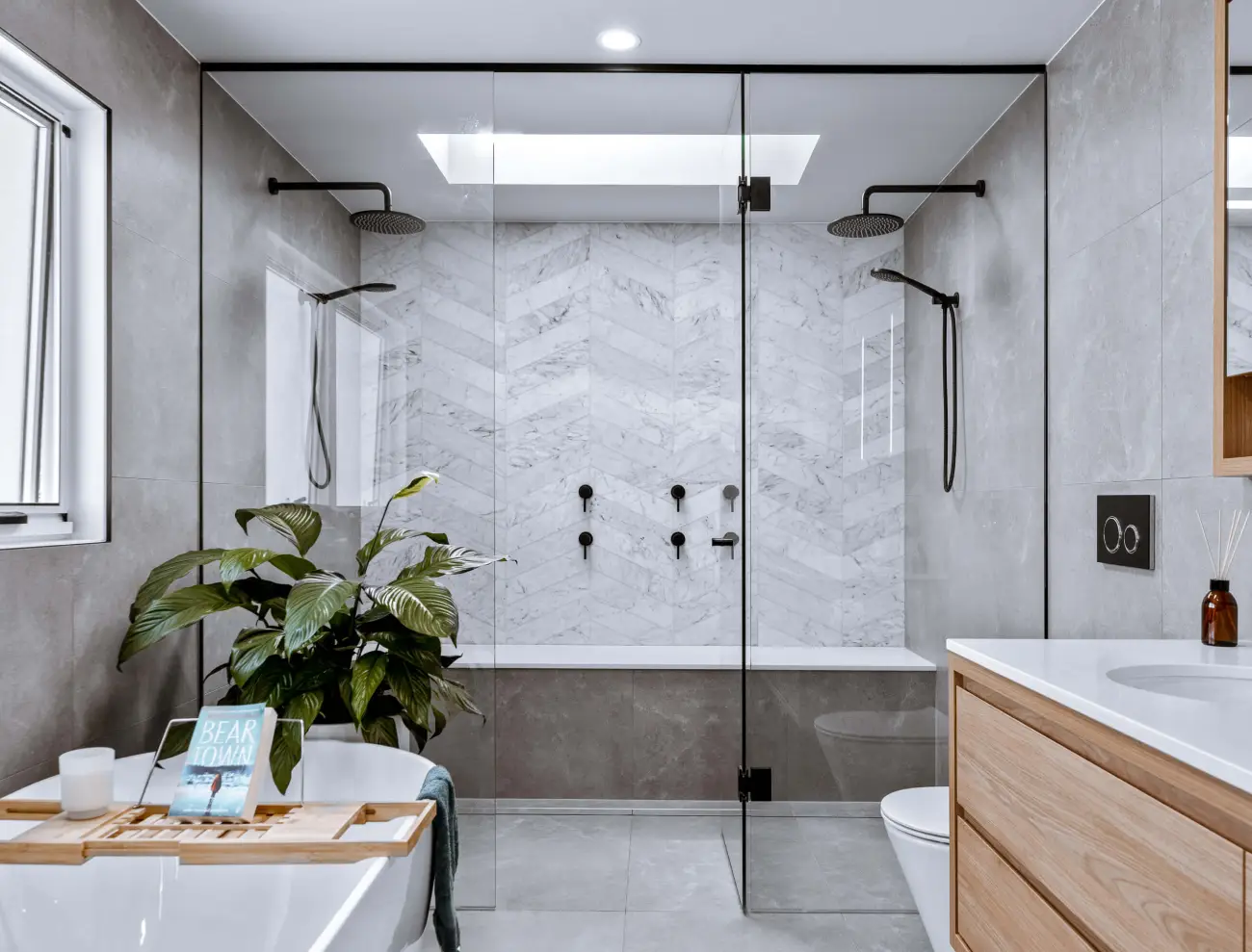 Luxury bathroom with freestanding tub, timber vanity, and large glass walk-in shower.
